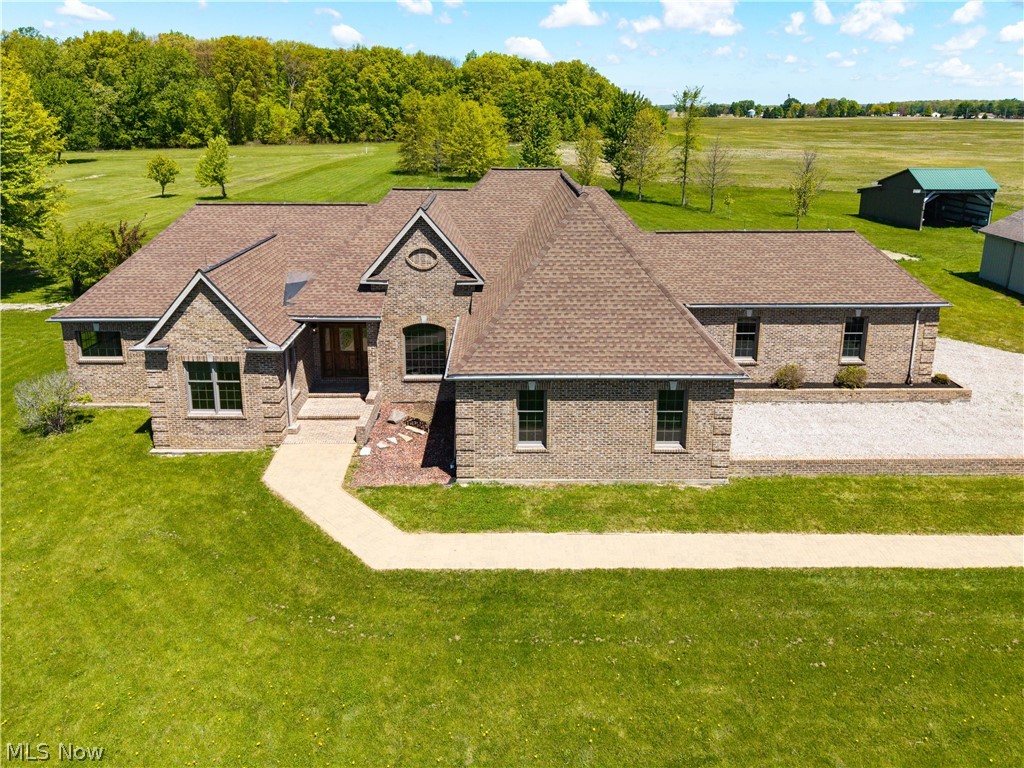 51488 Peck Wadsworth Road Wellington, OH 44090 - Photo 4 of 50 Expansive brick residence featuring a multi-gabled roofline and a gravel driveway