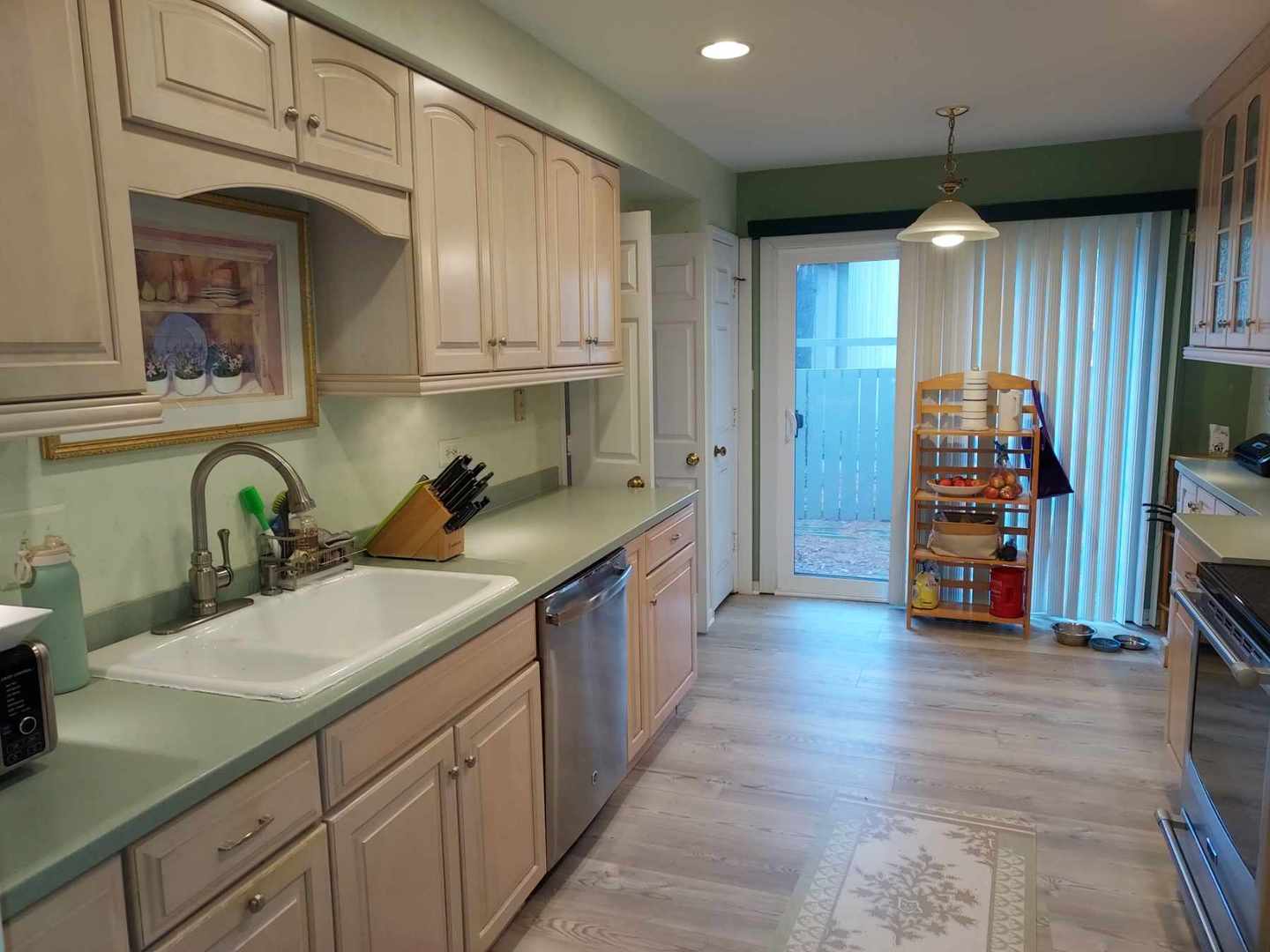 787 Oak Hill Road, Unit 467 Lake Barrington, IL 60010 - Photo 12 of 57 a large kitchen with stainless steel appliances lots of counter space and wooden floor