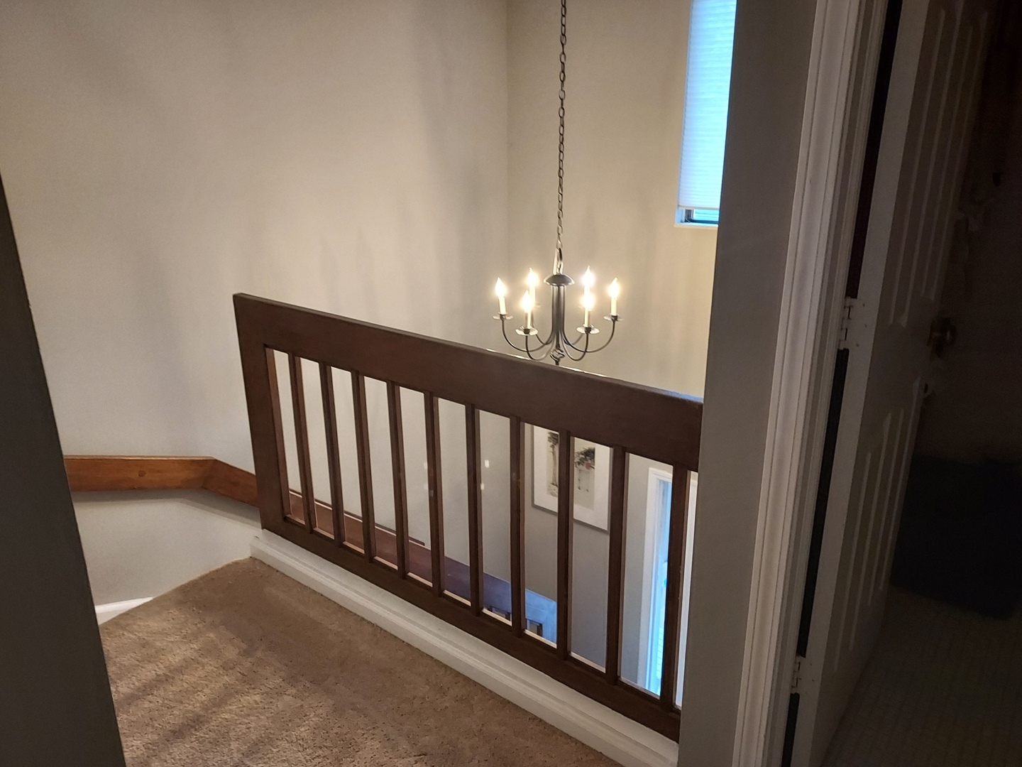 787 Oak Hill Road, Unit 467 Lake Barrington, IL 60010 - Photo 19 of 57 a view of a hallway with wooden floor and chandelier