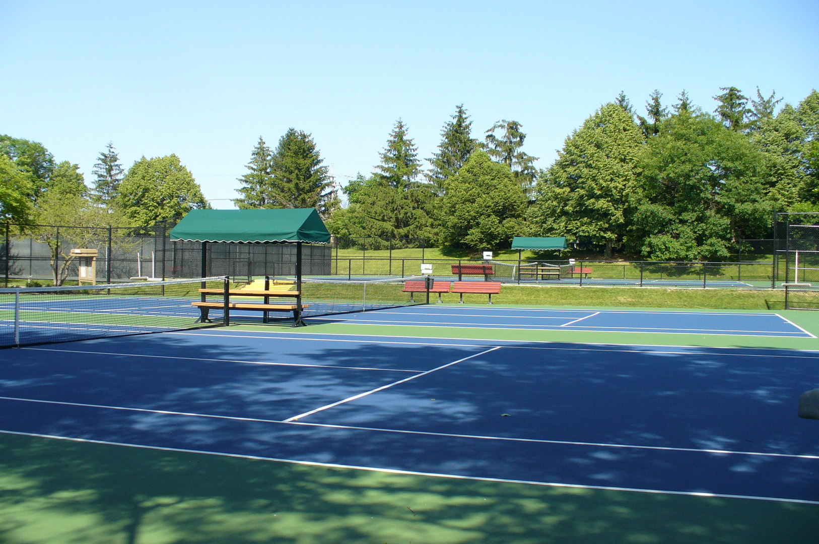 787 Oak Hill Road, Unit 467 Lake Barrington, IL 60010 - Photo 52 of 57 a view of a tennis ground with trees in the background