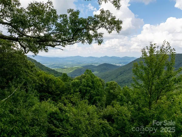 an aerial view of mountain with yard