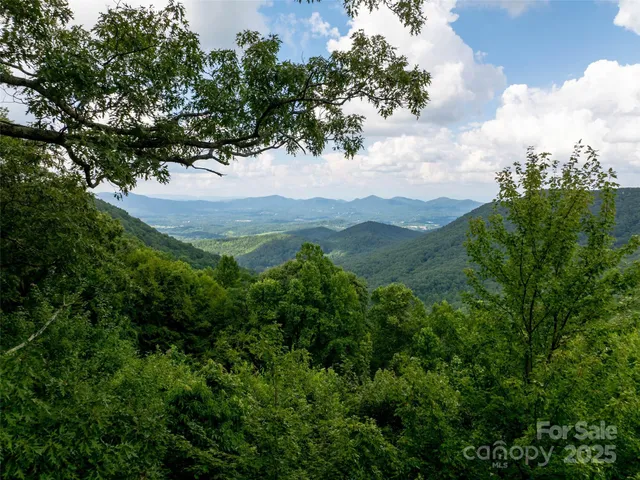 an aerial view of mountain with yard