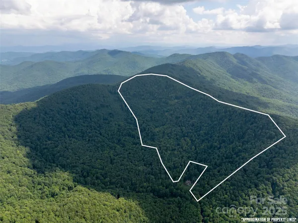 a view of a room with wooden floor and fence