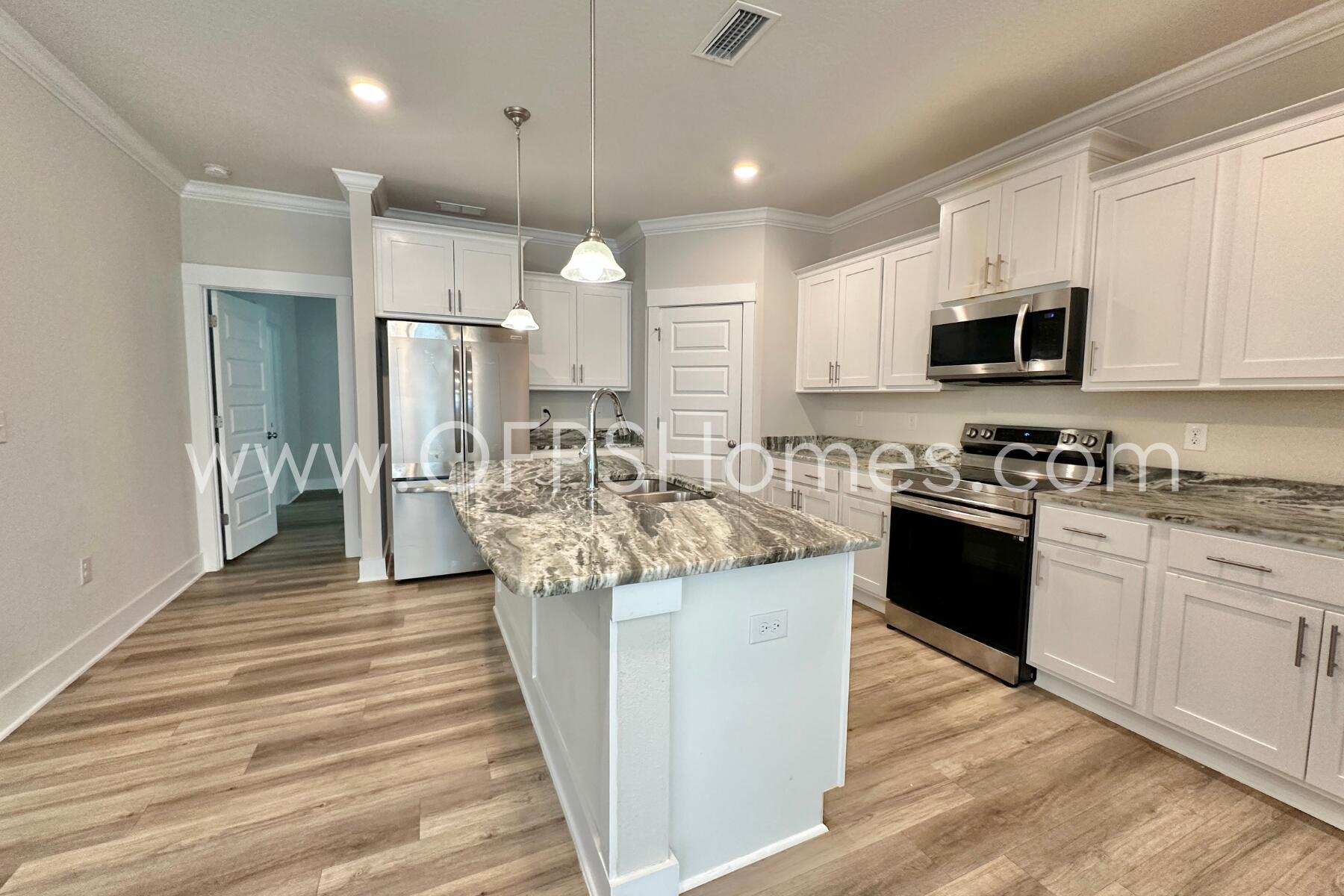 7422 Stagecoach Road Pensacola, FL 32526 - Photo 11 of 27 a kitchen with stainless steel appliances kitchen island granite countertop a sink and a stove top oven