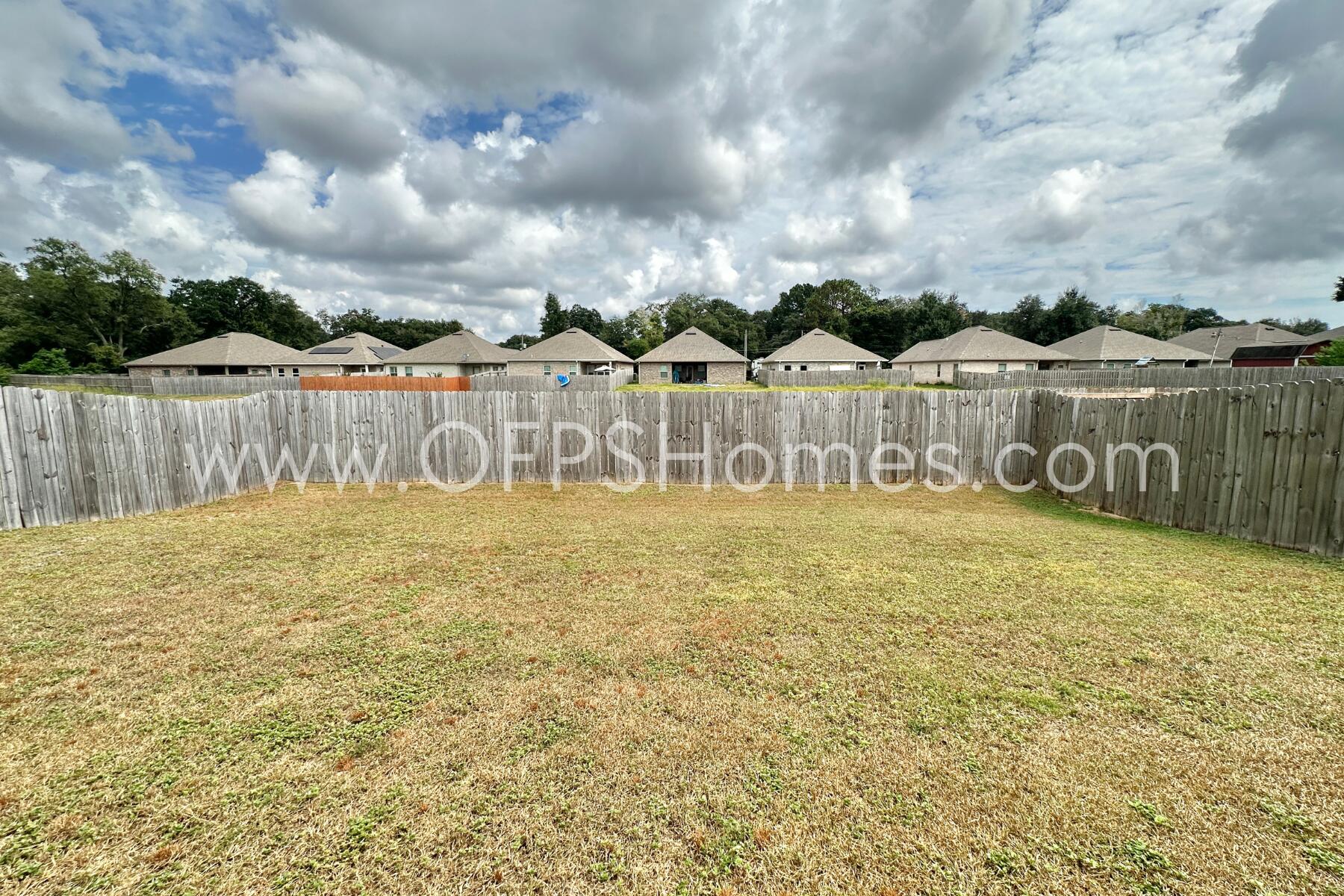 7422 Stagecoach Road Pensacola, FL 32526 - Photo 25 of 27 a front view of a house with a garden