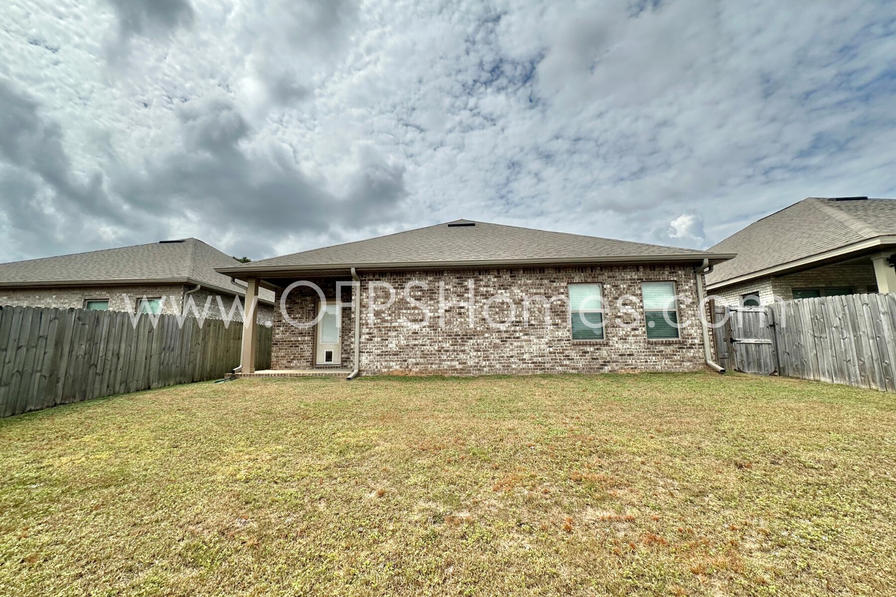 7422 Stagecoach Road Pensacola, FL 32526 - Photo 26 of 27 a view of a back yard with an tree in the house
