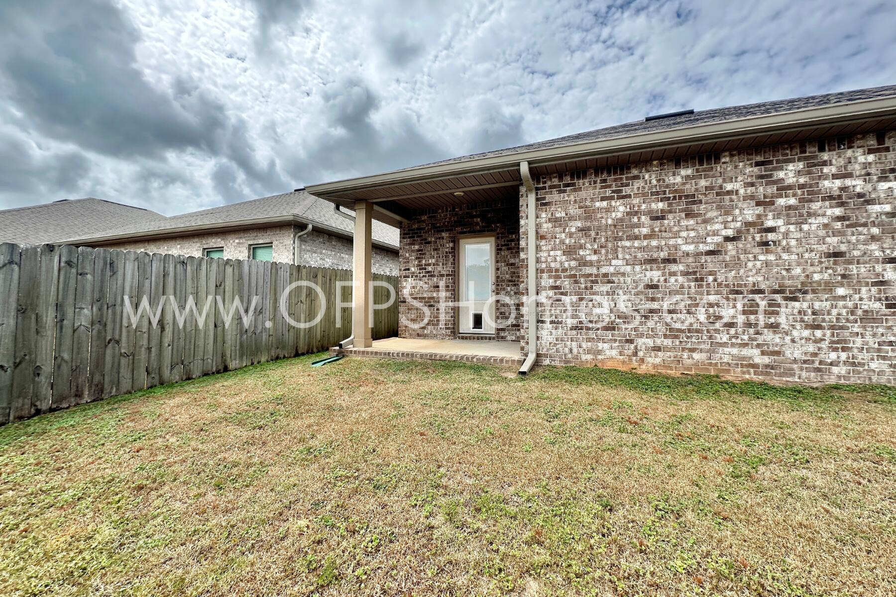 7422 Stagecoach Road Pensacola, FL 32526 - Photo 27 of 27 a view of a back yard of the house and a wooden fence