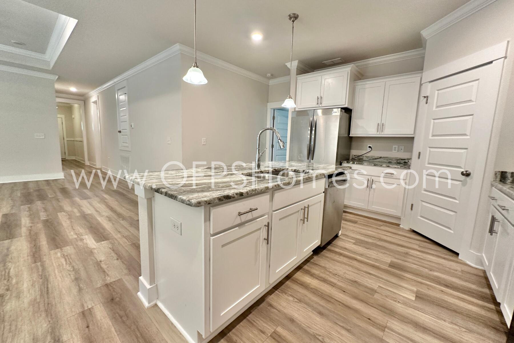 7422 Stagecoach Road Pensacola, FL 32526 - Photo 10 of 27 a kitchen with kitchen island white cabinets stainless steel appliances and sink