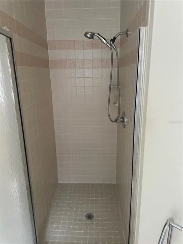 a bathroom with a glass shower door