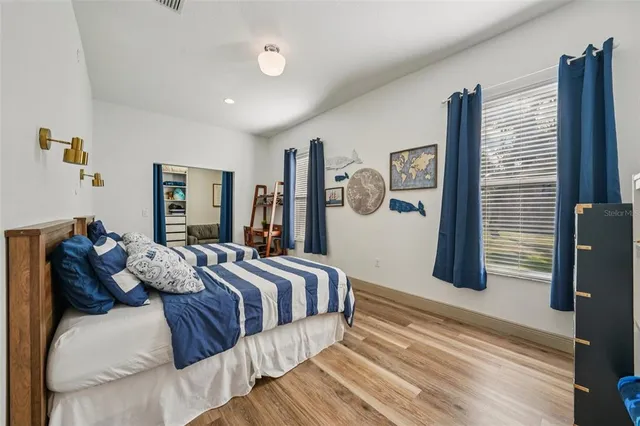 a bedroom with a bed and wooden floor