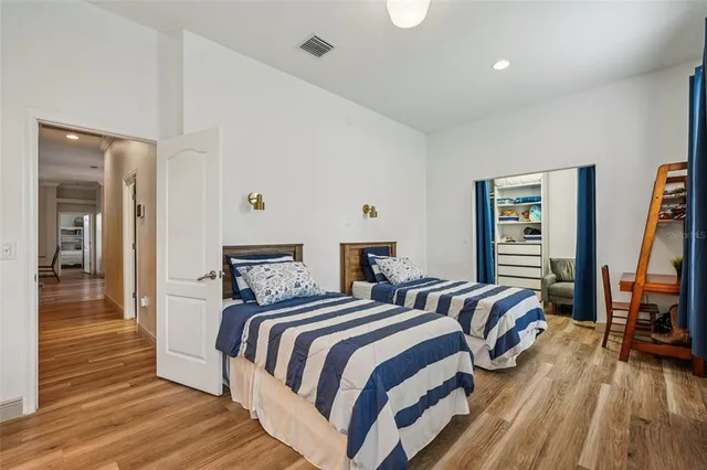 a bedroom with a large bed and a chandelier
