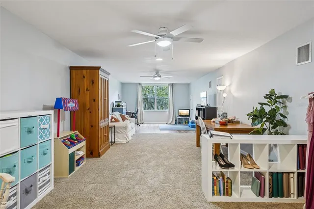 a view of a white house with a big yard and palm trees