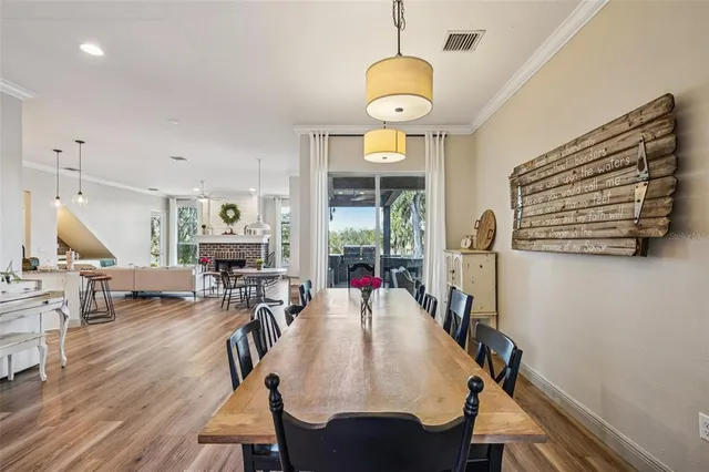 a view of a dining room with furniture wooden floor and chandelier