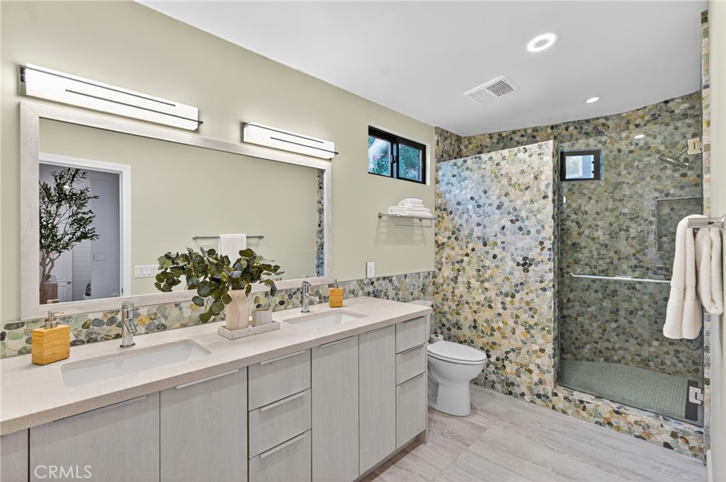 7582 McGroarty Terrace Los Angeles, CA 91042 - Photo 12 of 47 a bathroom with a sink mirror and toilet