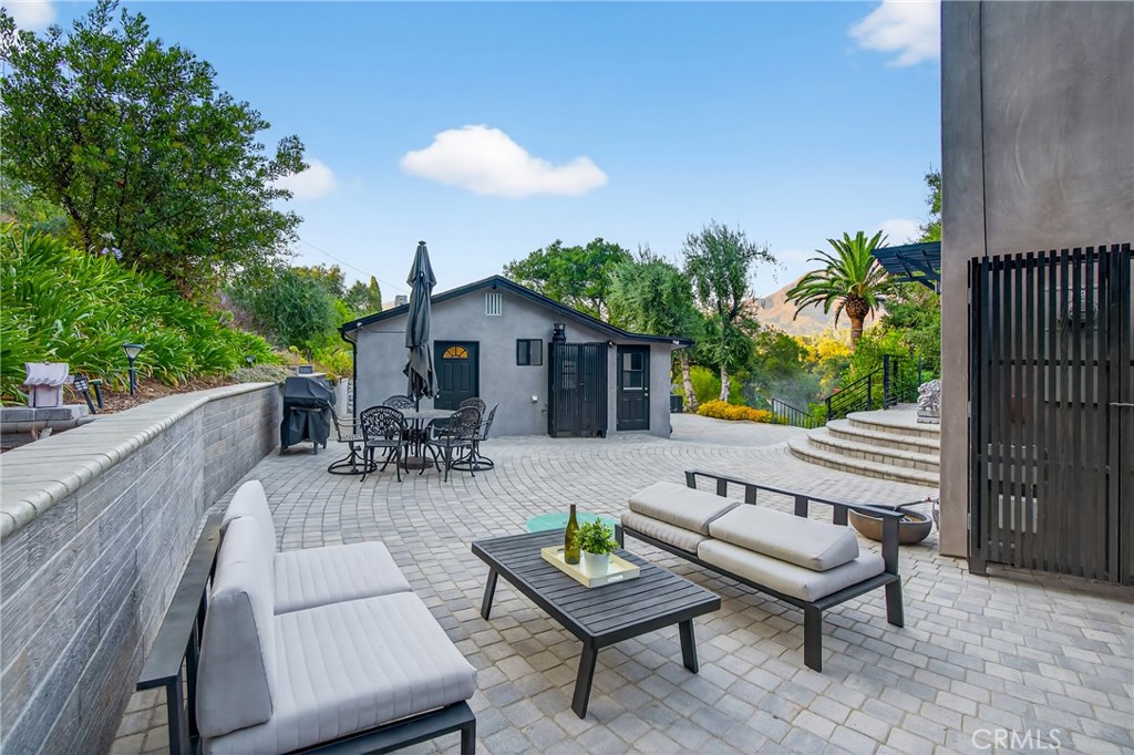 7582 McGroarty Terrace Los Angeles, CA 91042 - Photo 24 of 47 a view of a patio with a table and chairs