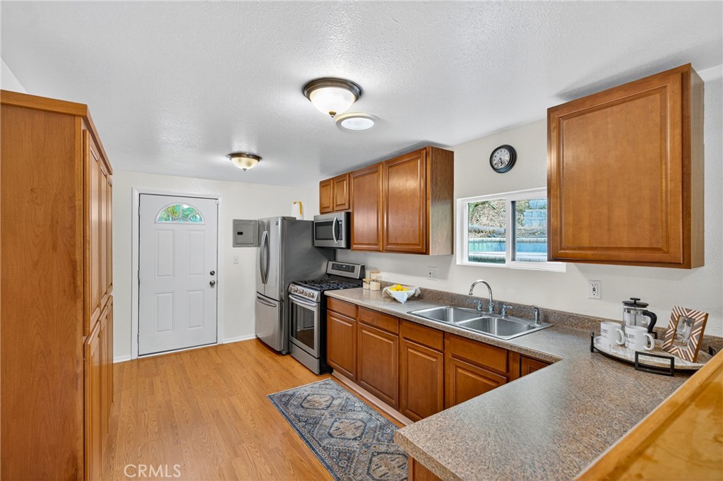 7582 McGroarty Terrace Los Angeles, CA 91042 - Photo 26 of 47 a kitchen with stainless steel appliances granite countertop a sink stove and refrigerator