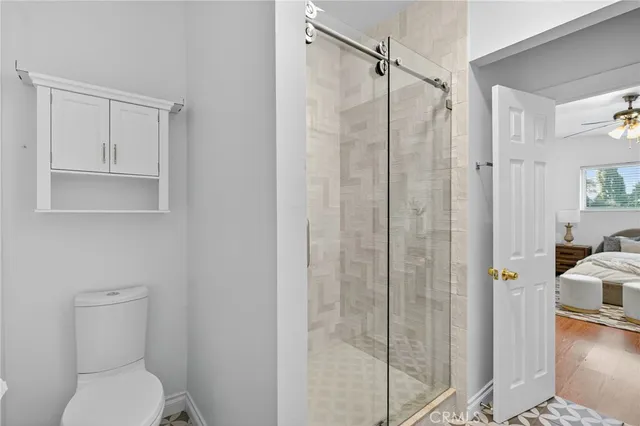 a bathroom with a granite countertop toilet sink and shower