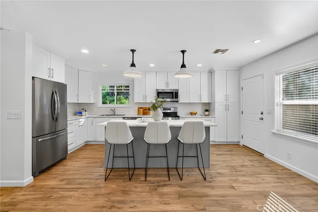 a kitchen with a stove a sink and a refrigerator