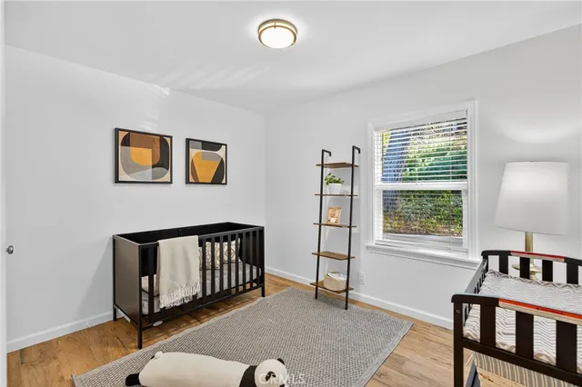 a bedroom with a bed and a potted plant