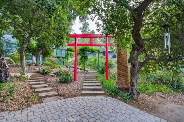 a backyard of a house with table and chairs