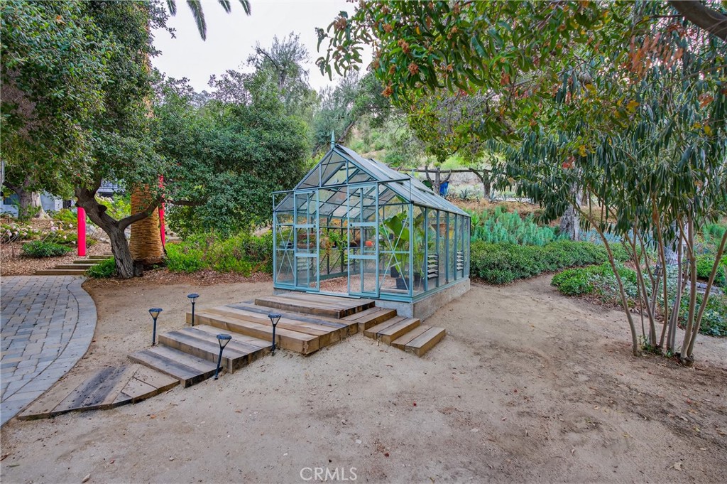 7582 McGroarty Terrace Los Angeles, CA 91042 - Photo 42 of 47 a backyard of a house with table and chairs