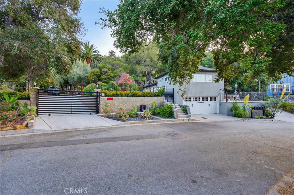 7582 McGroarty Terrace Los Angeles, CA 91042 - Photo 46 of 47 a front view of a house with a yard and a garage
