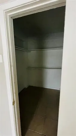 a view of a livingroom with an empty space and a window