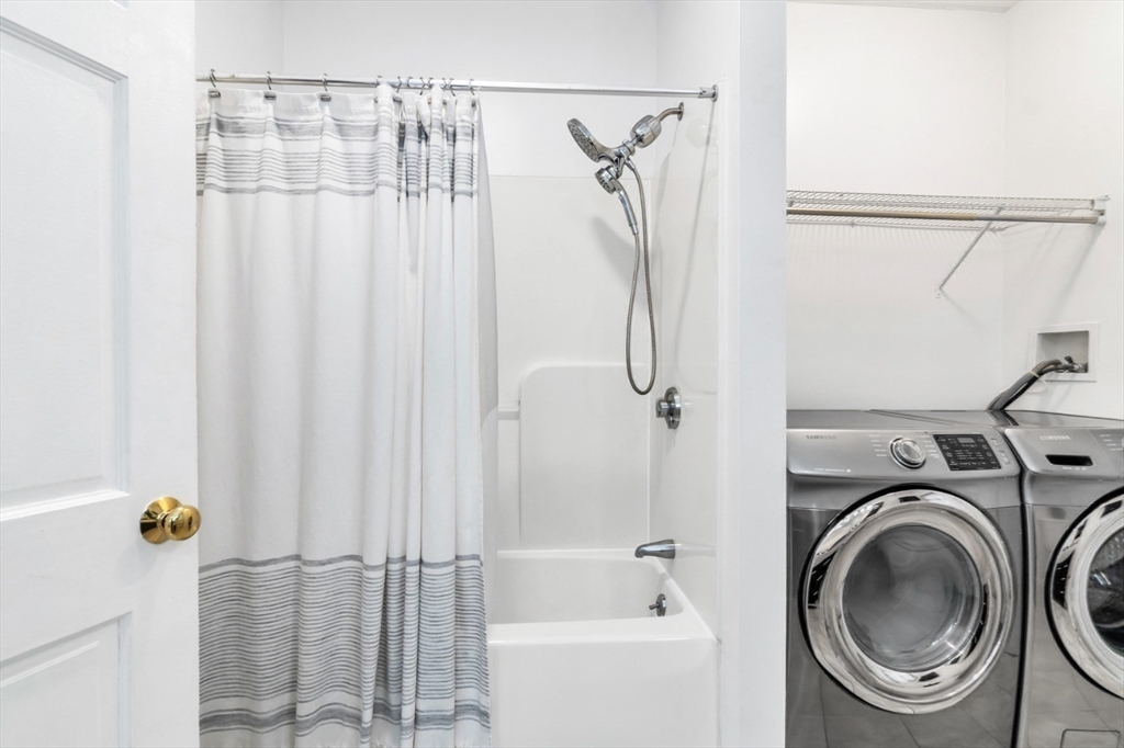 42 D Street Lowell, MA 01851 - Photo 19 of 27 a bathroom with a sink a washer and dryer
