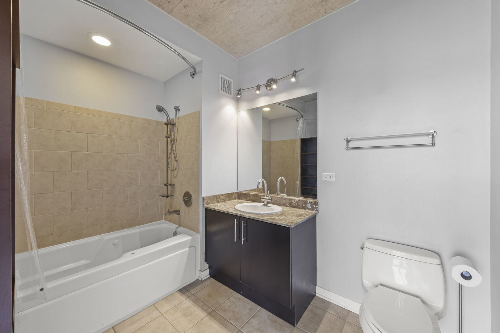 611 South Wells Street, Unit 2402 Chicago, IL 60607 - Photo 11 of 33 a bathroom with a granite countertop sink a toilet and shower