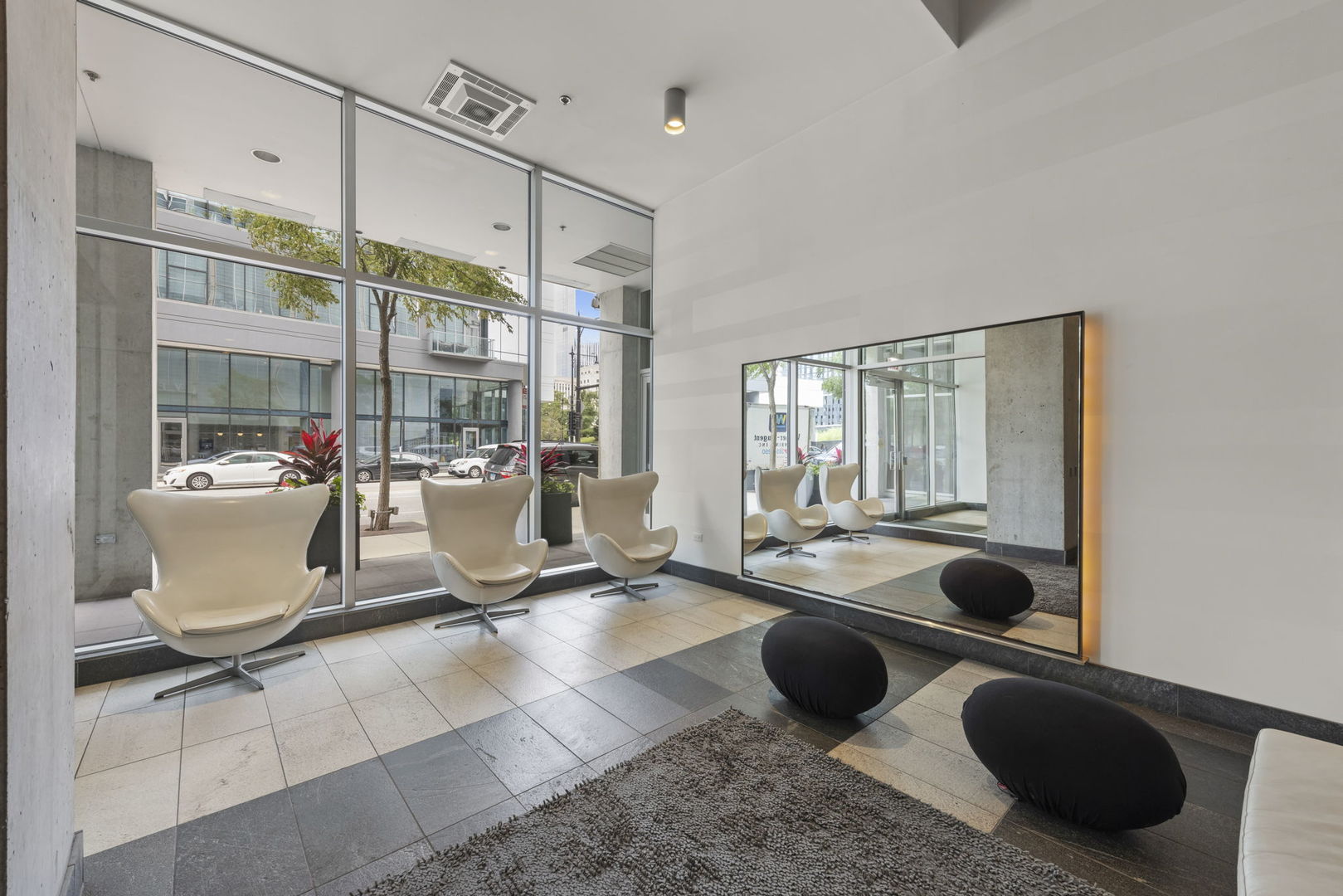 611 South Wells Street, Unit 2402 Chicago, IL 60607 - Photo 14 of 33 a room with table chairs and glass door