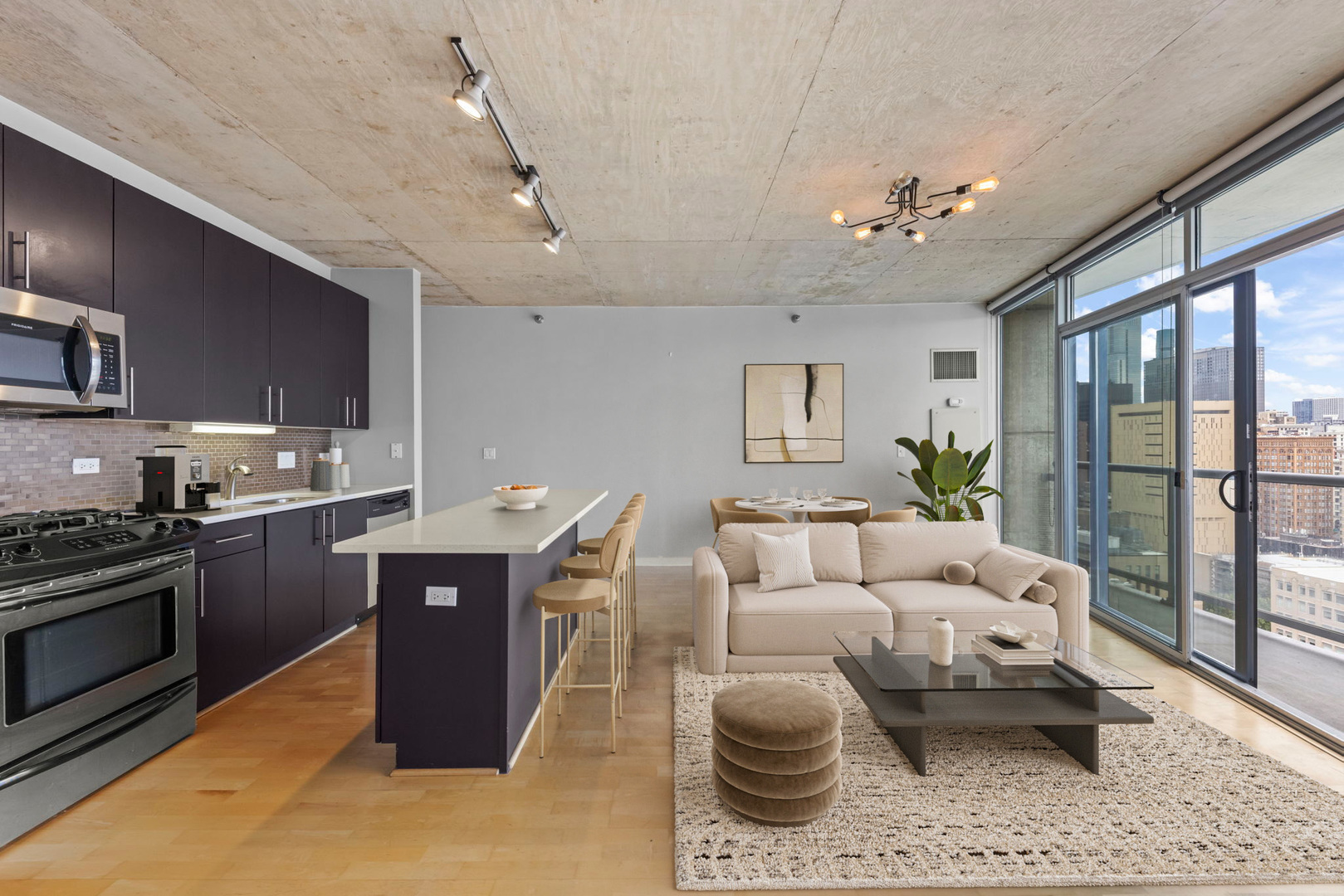 611 South Wells Street, Unit 2402 Chicago, IL 60607 - Photo 6 of 33 a living room with furniture a rug kitchen view and a chandelier