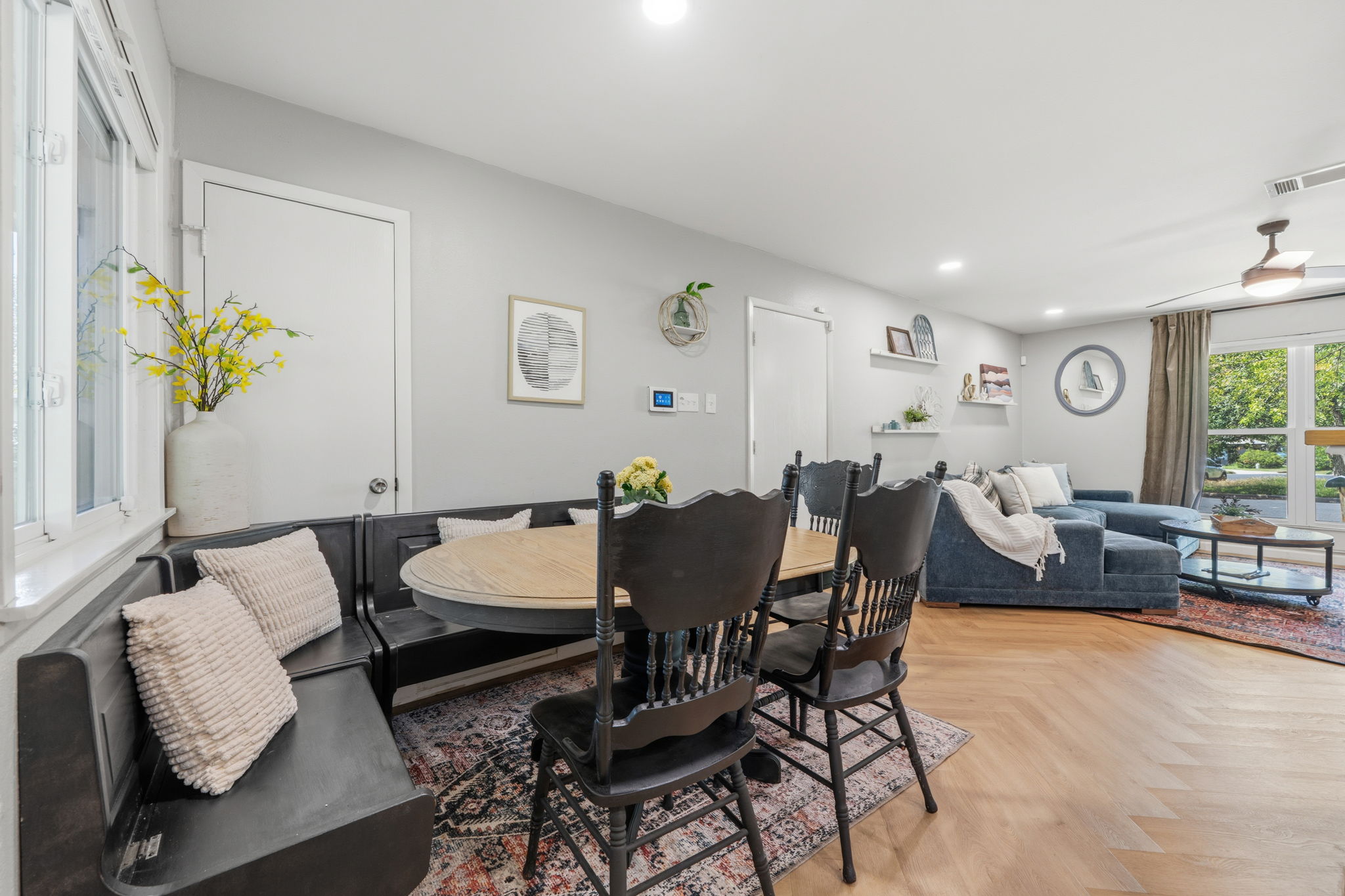 705 Dulwich Street Austin, TX 78748 - Photo 5 of 36 Herringbone hardwood floors complement the natural light streaming into this inviting dining area and living space.