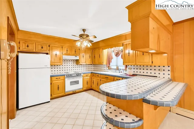 a view of an empty room with window furniture and front door