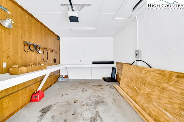 a view of a swimming pool with a garden and seating area