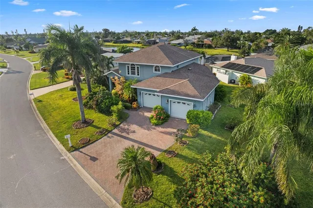 an aerial view of residential houses with outdoor space and swimming pool