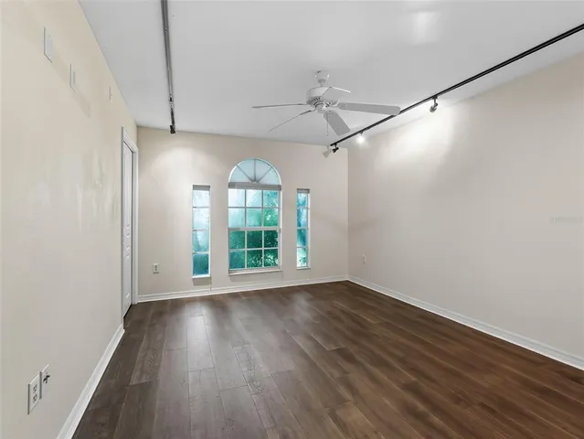 a view of room with window and wooden floor
