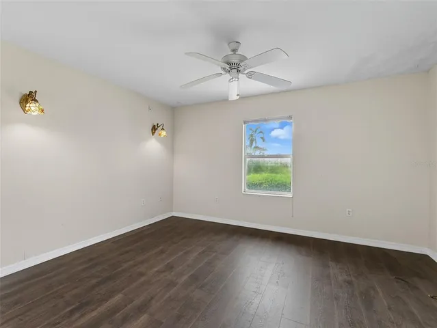 wooden floor in an empty room with a window