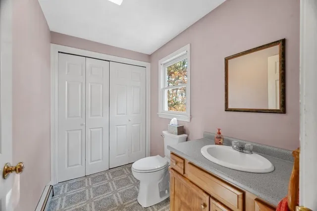 a bathroom with a granite countertop sink toilet a mirror and a shower