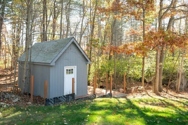 a view of backyard of house with green space