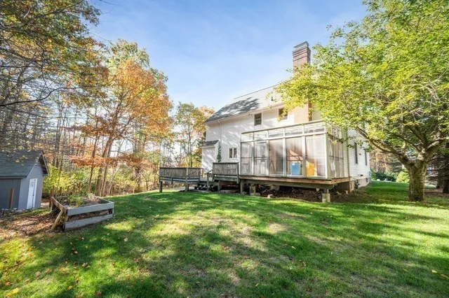 a view of a house with a yard and sitting area