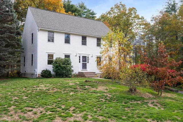 a front view of house with yard and green space