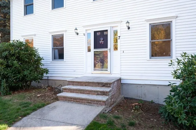 a view of a house with a yard and sitting area