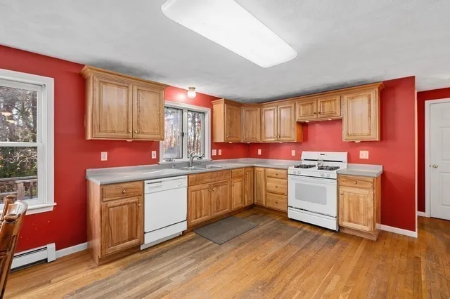a kitchen with granite countertop a stove top oven sink and cabinets