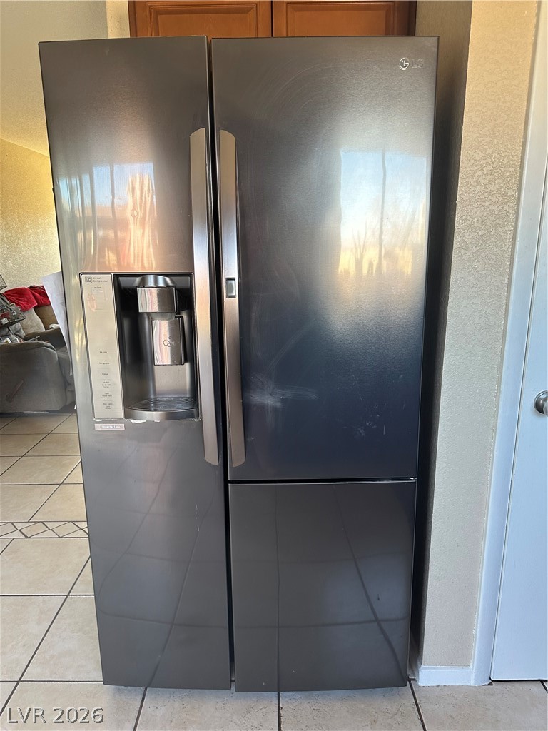 233 Ash Street Henderson, NV 89015 - Photo 12 of 20 Kitchen view of stainless steel refrigerator with ice dispenser and a textured wall