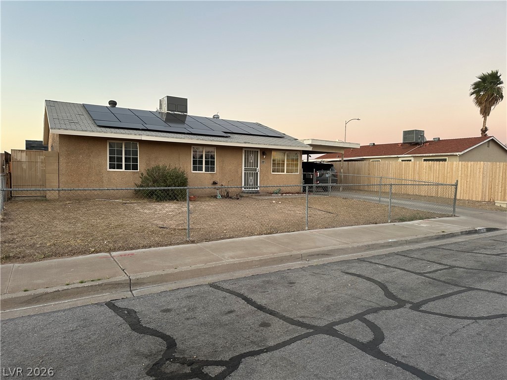 233 Ash Street Henderson, NV 89015 - Photo 19 of 20 Single story home featuring stucco siding, roof mounted solar panels, and a fenced front yard