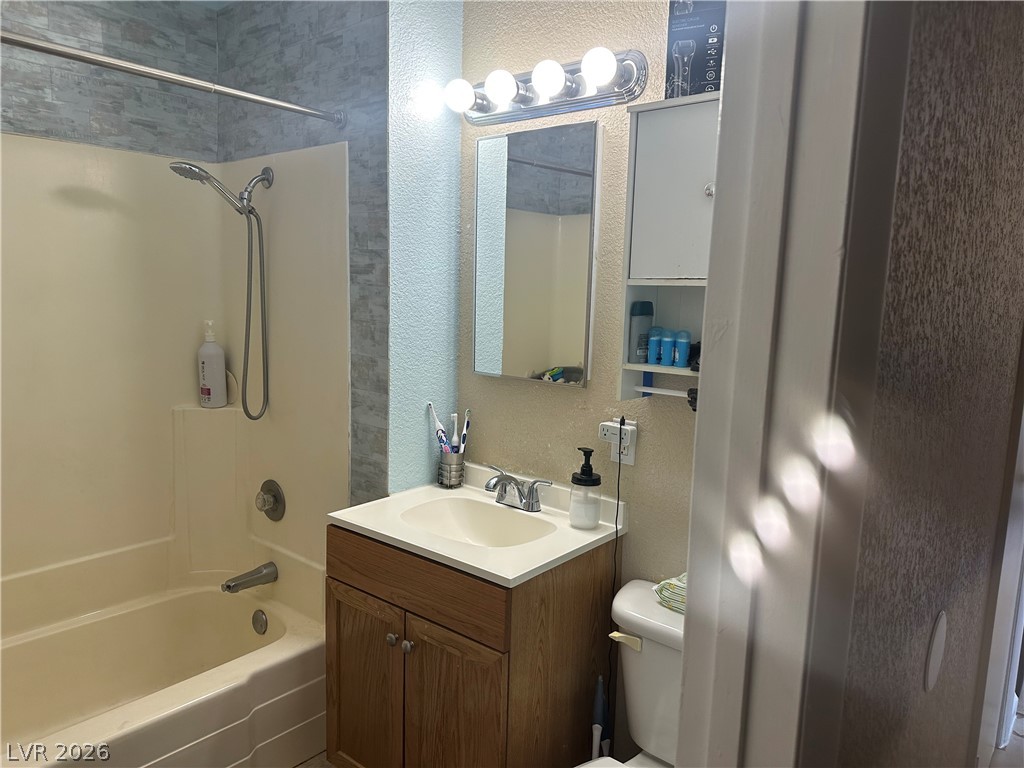 233 Ash Street Henderson, NV 89015 - Photo 10 of 20 Bathroom with a textured wall, vanity, and bathing tub / shower combination