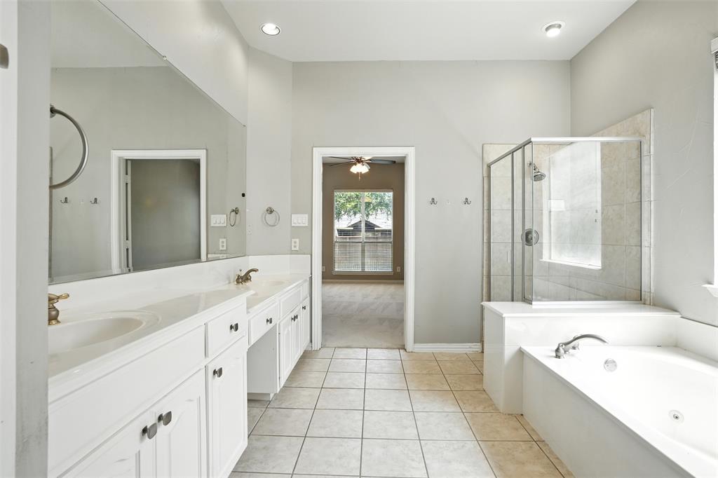 8220 Holliday Road Lantana, TX 76226 - Photo 23 of 40 Bathroom featuring dual vanity with an expansive mirror, white cabinetry, and light-colored countertops