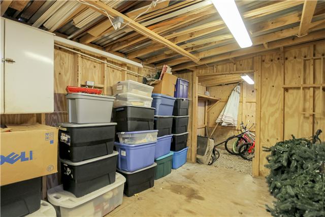 375 Edmondson Ferry Road Clarksville, TN 37040 - Photo 19 of 20 View of workshop from the other side of building. A peck into the graveled area for storing yard care items and bicycles.
