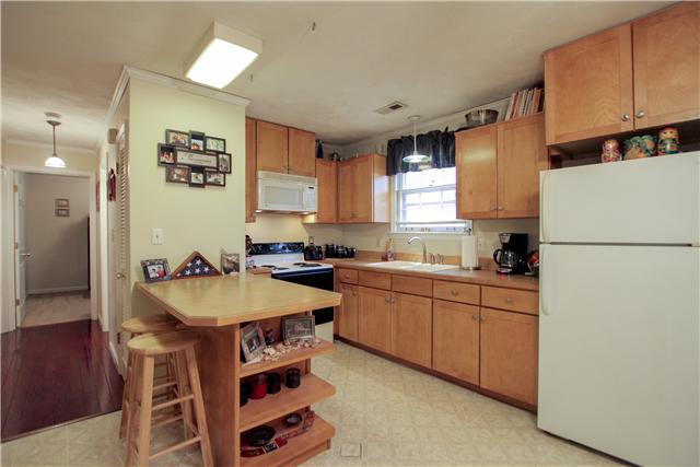 375 Edmondson Ferry Road Clarksville, TN 37040 - Photo 2 of 20 Nice, clean custom cabinets with additional seating at the bar. All matching white appliances.