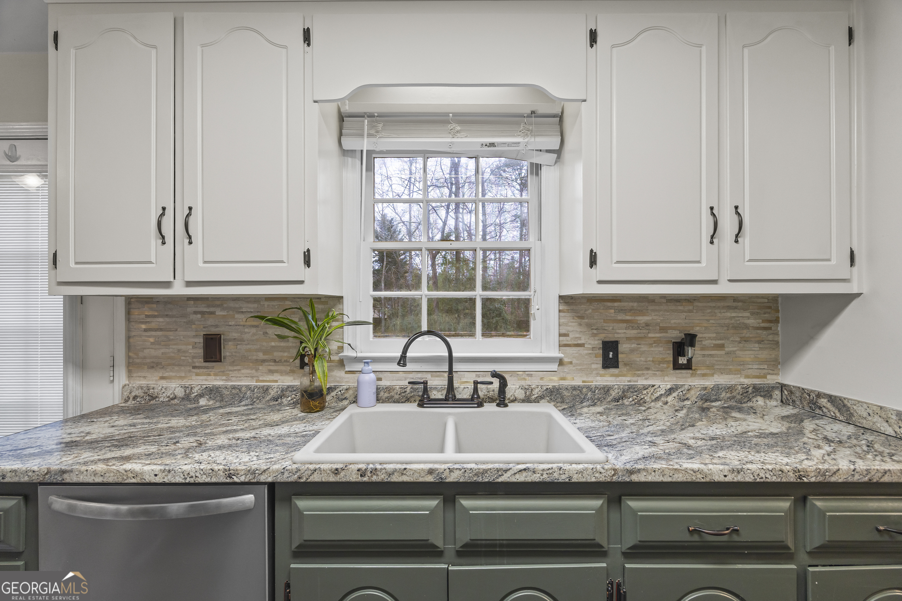 129 Pheasant Run Bogart, GA 30622 - Photo 23 of 50 a kitchen with granite countertop a sink and a window